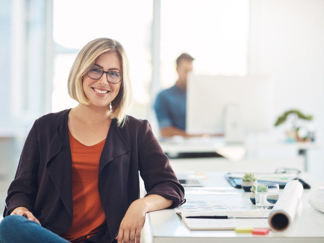 Home energy advisor smiling at her desk