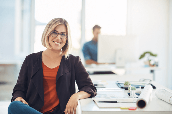 Home energy advisor smiling at her desk